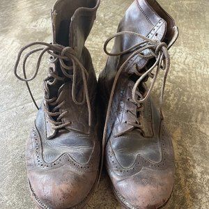Wing tipped brown leather boots